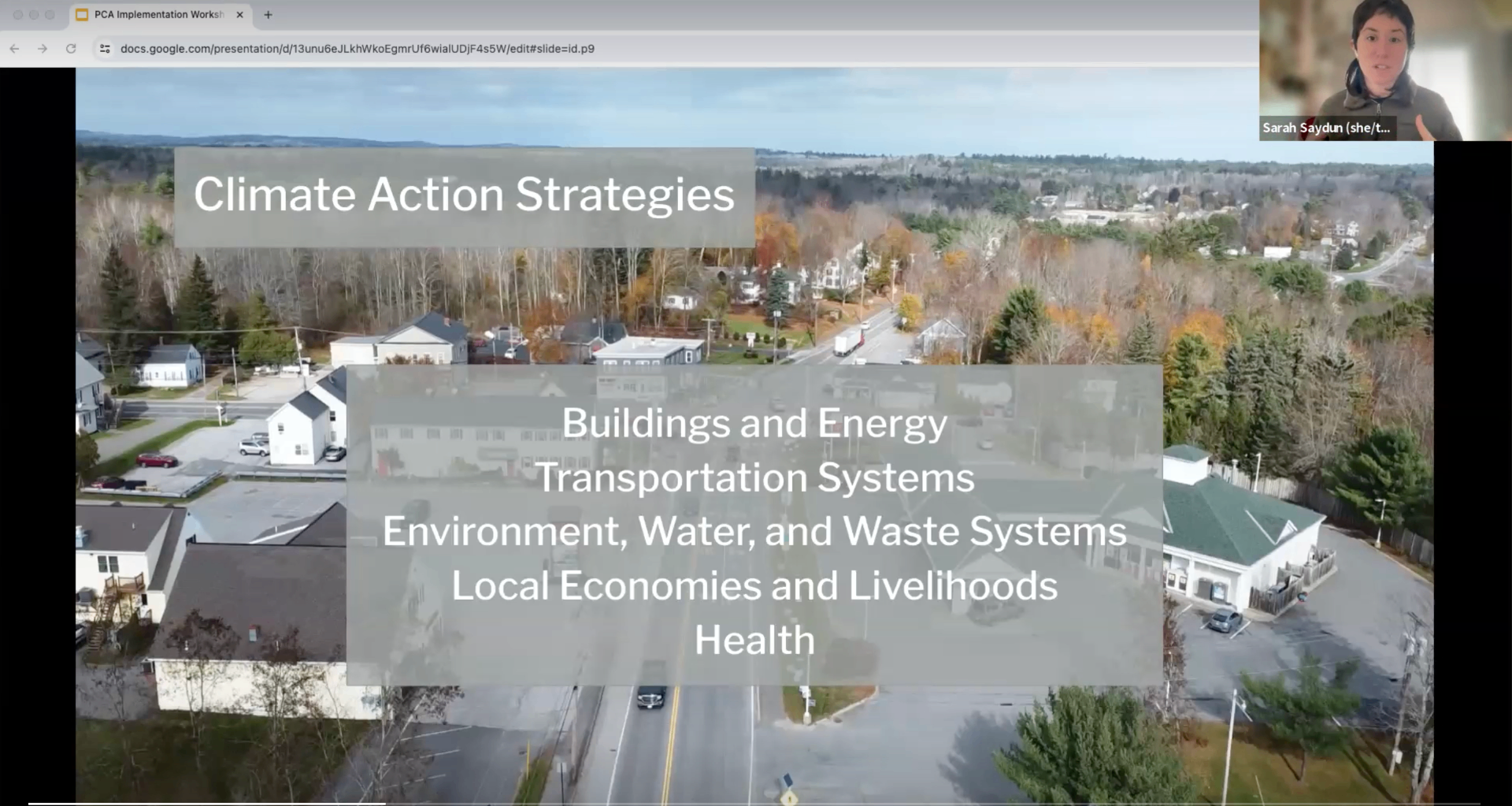 Slide titled Climate Action Strategies listing Buildings and Energy, Transportation Systems, Environment/Water/Waste Systems, Local Economies and Livelihoods, and Health, overlaid on an aerial photo of a Maine town.
